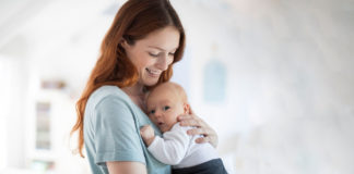 1…2…3…run to the wall! Freeze! Playful parenting baby in mother's arms